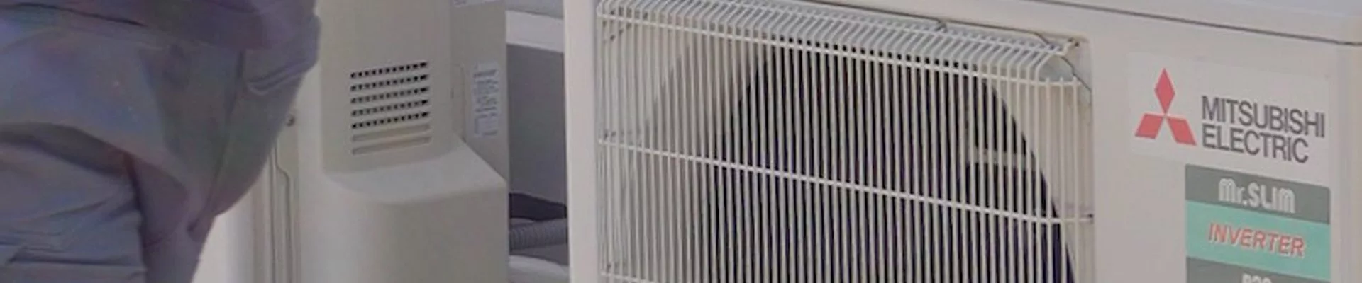 Technician checking an AC outdoor unit