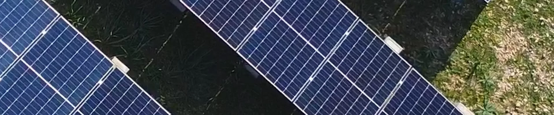 Drone view of solar module rows on a hillside