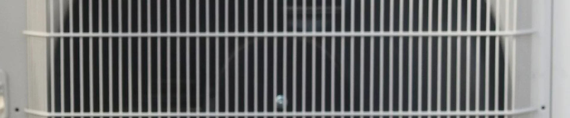air conditioning energy consumption: Close-up of the fan grille of an AC outdoor unit air conditioning energy consumption: Close-up of the fan grille of an AC outdoor unit