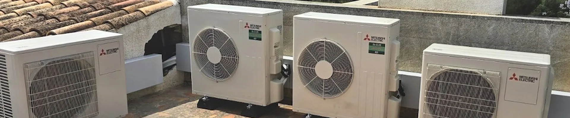Outdoor units of split air conditioners on a Mallorca roof terrace